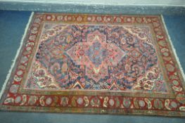 A BLUE GROUND KASHAN STYLE RUG, with a foliate multistrap border, with a central medallion 203cm x
