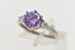 A WHITE METAL CUBIC ZIRCONIA RING, set with a circular cut purple cubic zirconia in a six claw