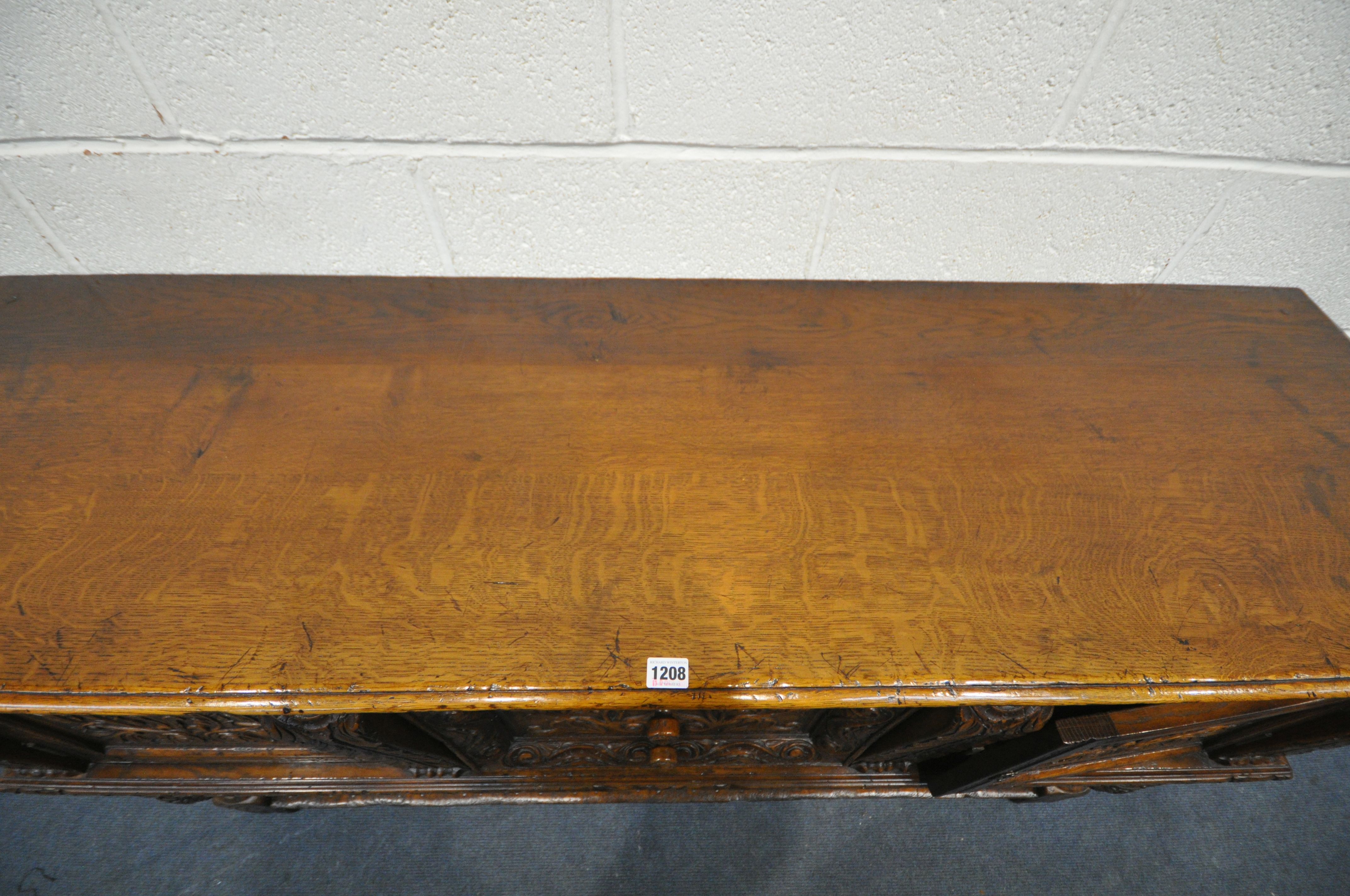 A REPRODUCTION SOLID OAK DRESSER BASE, with two cupboard doors, flanking two drawers, on twin - Image 2 of 4
