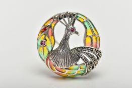 A WHITE METAL PLIQUE A JOUR PEACOCK BROOCH/PENDANT, of a circular openwork design displaying a