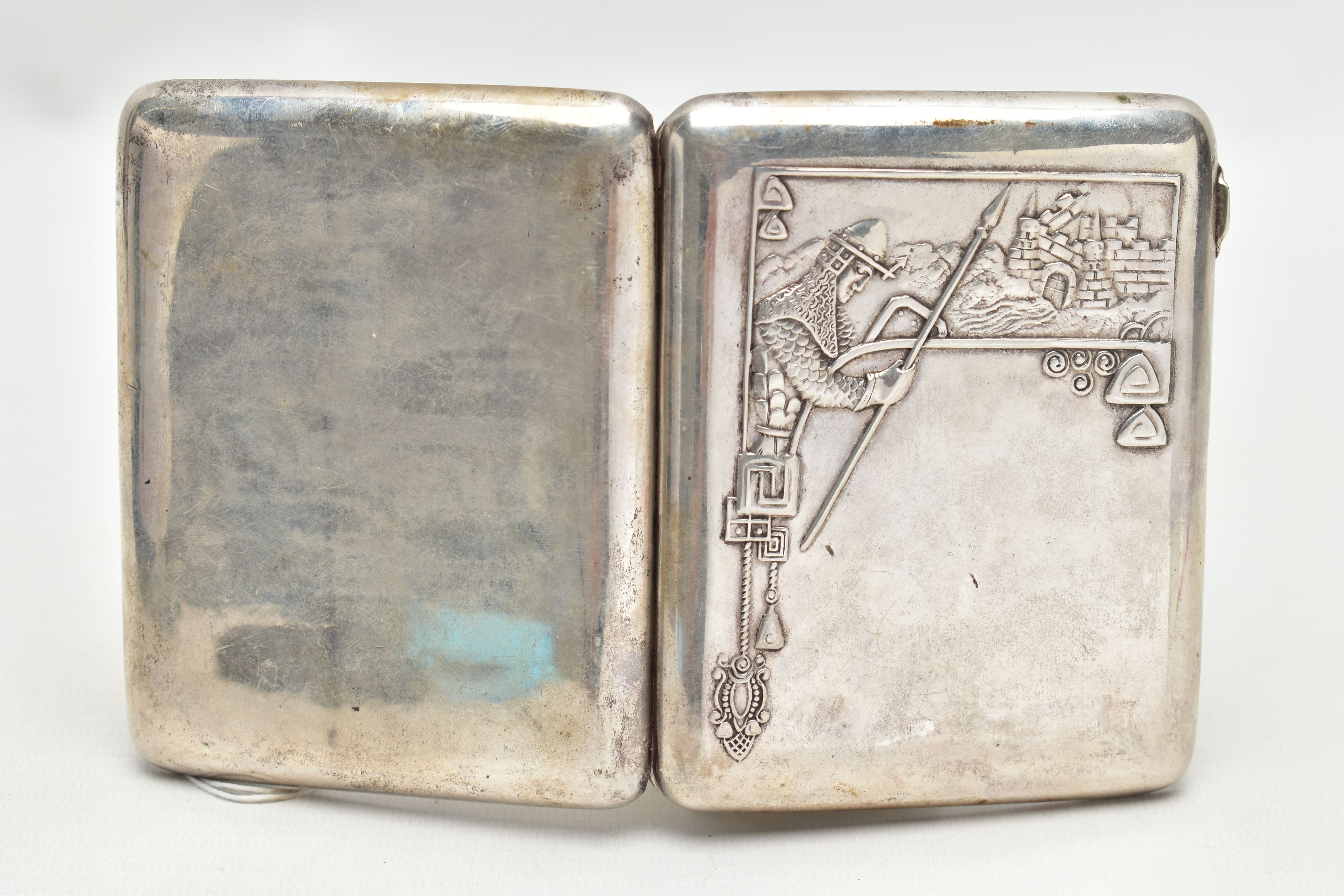 A RUSSIAN SILVER CIGARETTE CASE, of a rounded rectangular form, embossed soldier and castle design