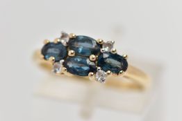 A 9CT GOLD SAPPHIRE AND TOPAZ RING, set with four oval cut blue sapphires, each in a four claw