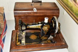 AN EDWARDIAN JONES SEWING MACHINE, with a wooden carry case, model No. 288479 as supplied to her