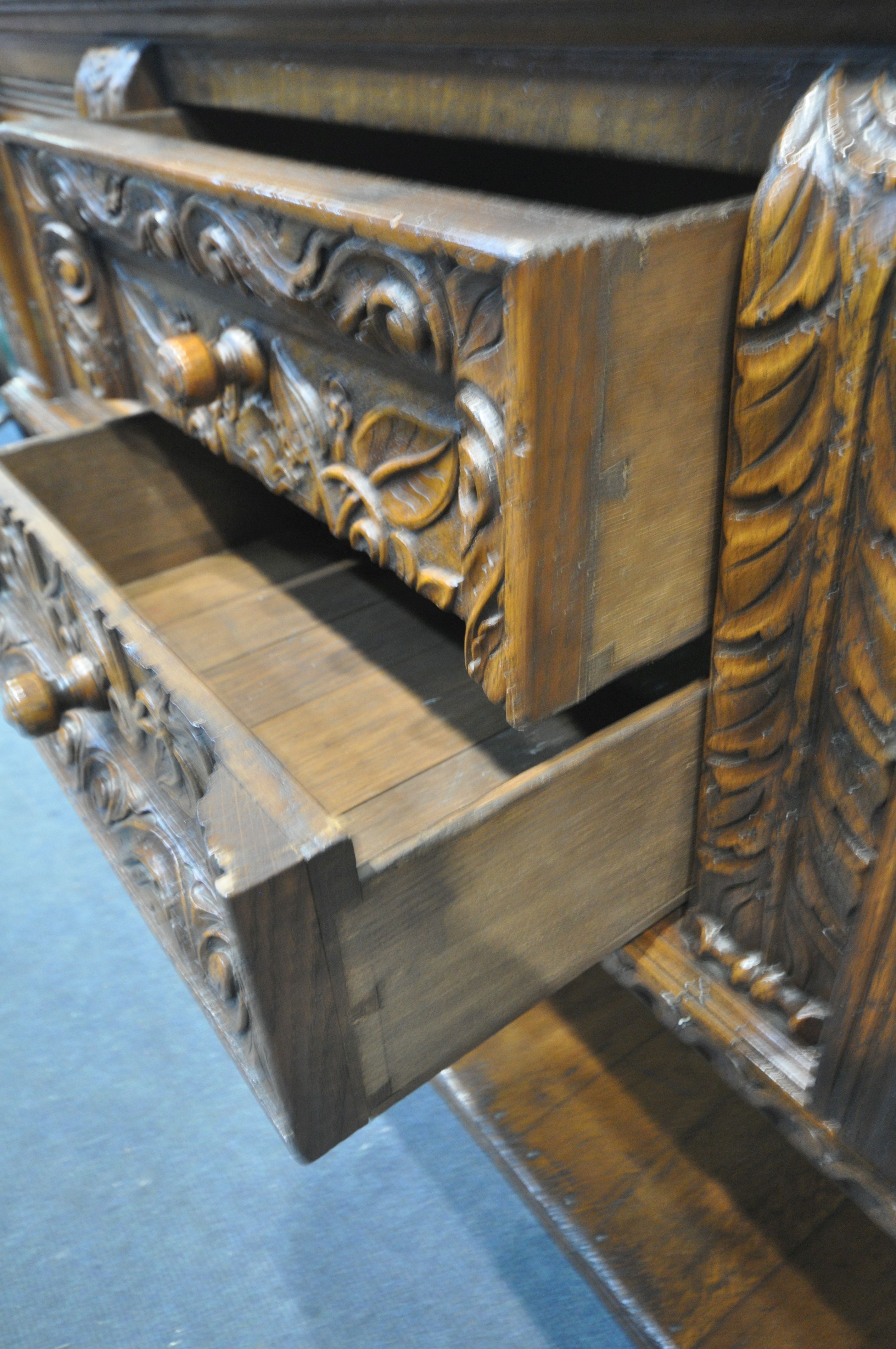 A REPRODUCTION SOLID OAK DRESSER BASE, with two cupboard doors, flanking two drawers, on twin - Image 4 of 4