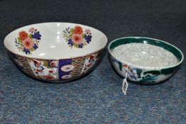 TWO TWENTIETH CENTURY ORIENTAL BOWLS one having repeating panels of floral and geometric motifs,