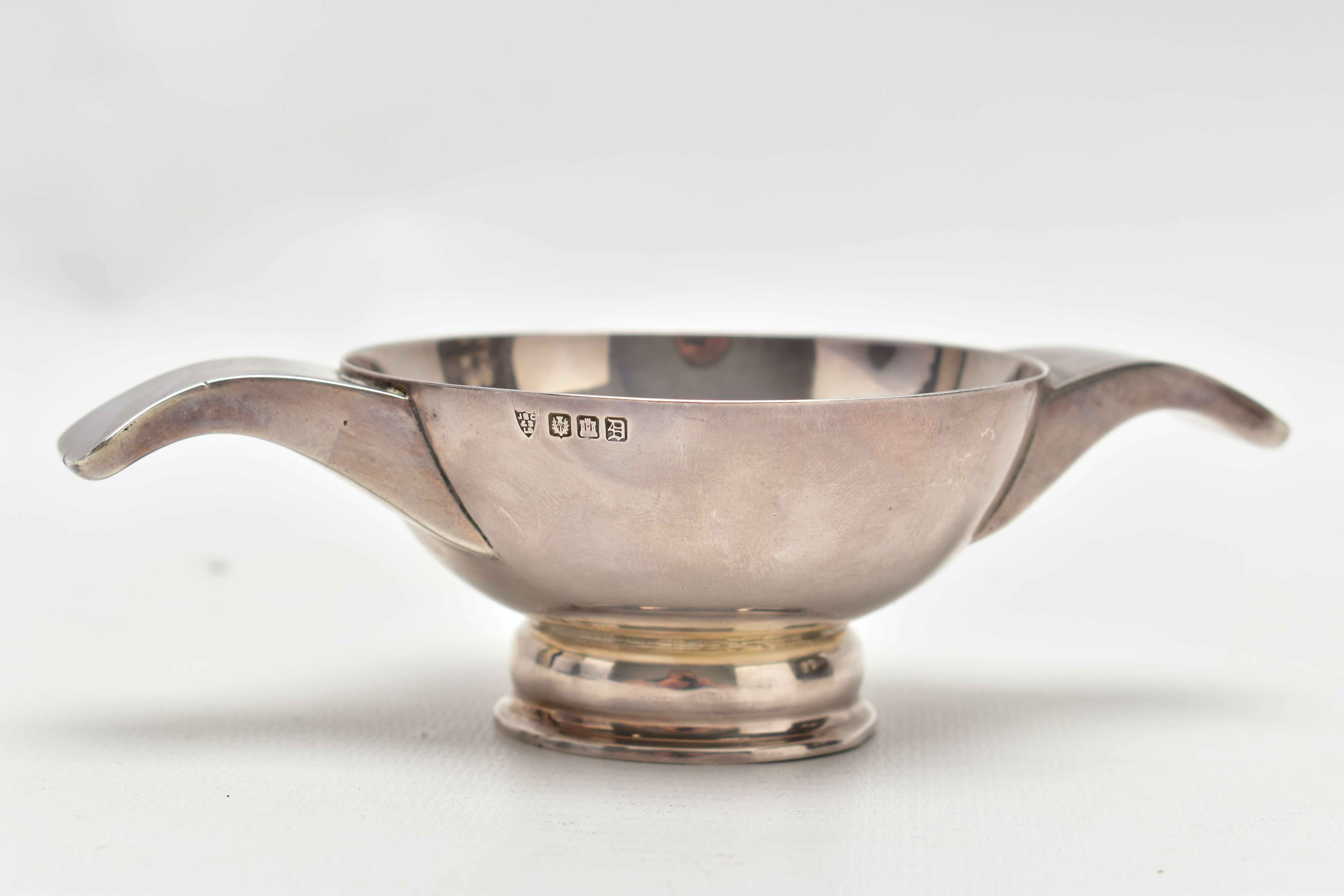 A SCOTTISH SILVER QUAICH, small silver polished Quaich with double handles, hallmarked 'J B