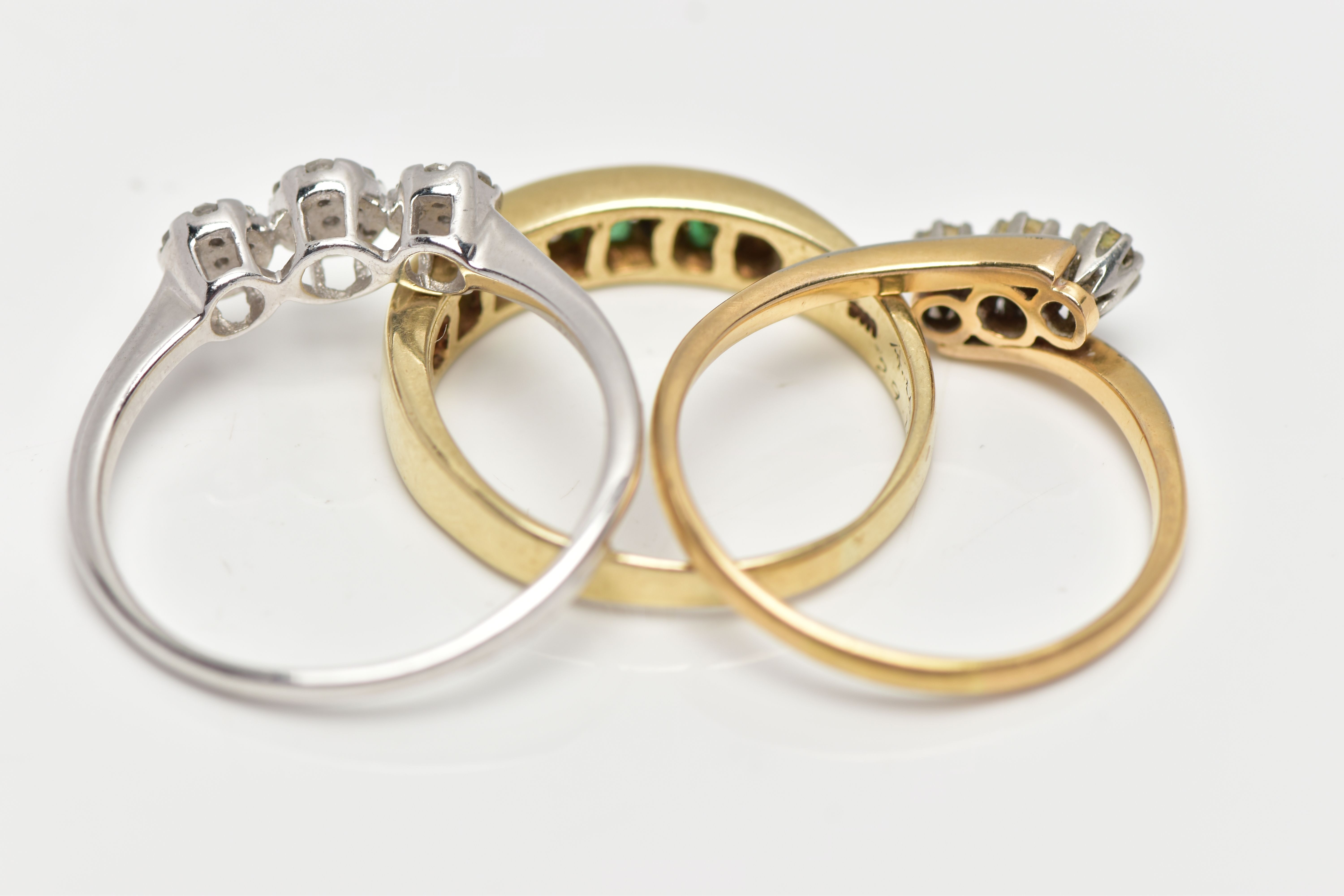 THREE GEM SET RINGS, the first a yellow metal half eternity ring set with four square cut emeralds - Image 4 of 4