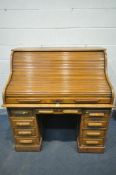 A 20TH CENTURY OAK ROLL TOP DESK, with a fitted interior of a quantity of pigeon holes and two