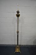 A BRASS FLOOR STANDING TELESCOPIC CORINTHIAN COLUMN OIL LAMP, on a stepped base with claw feet,