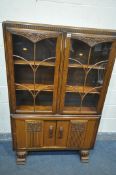 A MID CENTURY OAK BOOKCASE, with two glazed doors and two cupboard doors, width 100cm x depth 33cm x