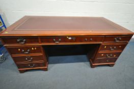 A 20TH CENTURY CHERRYWOOD TWIN PEDESTAL DESK, with burgundy and tooled leather writing surface,