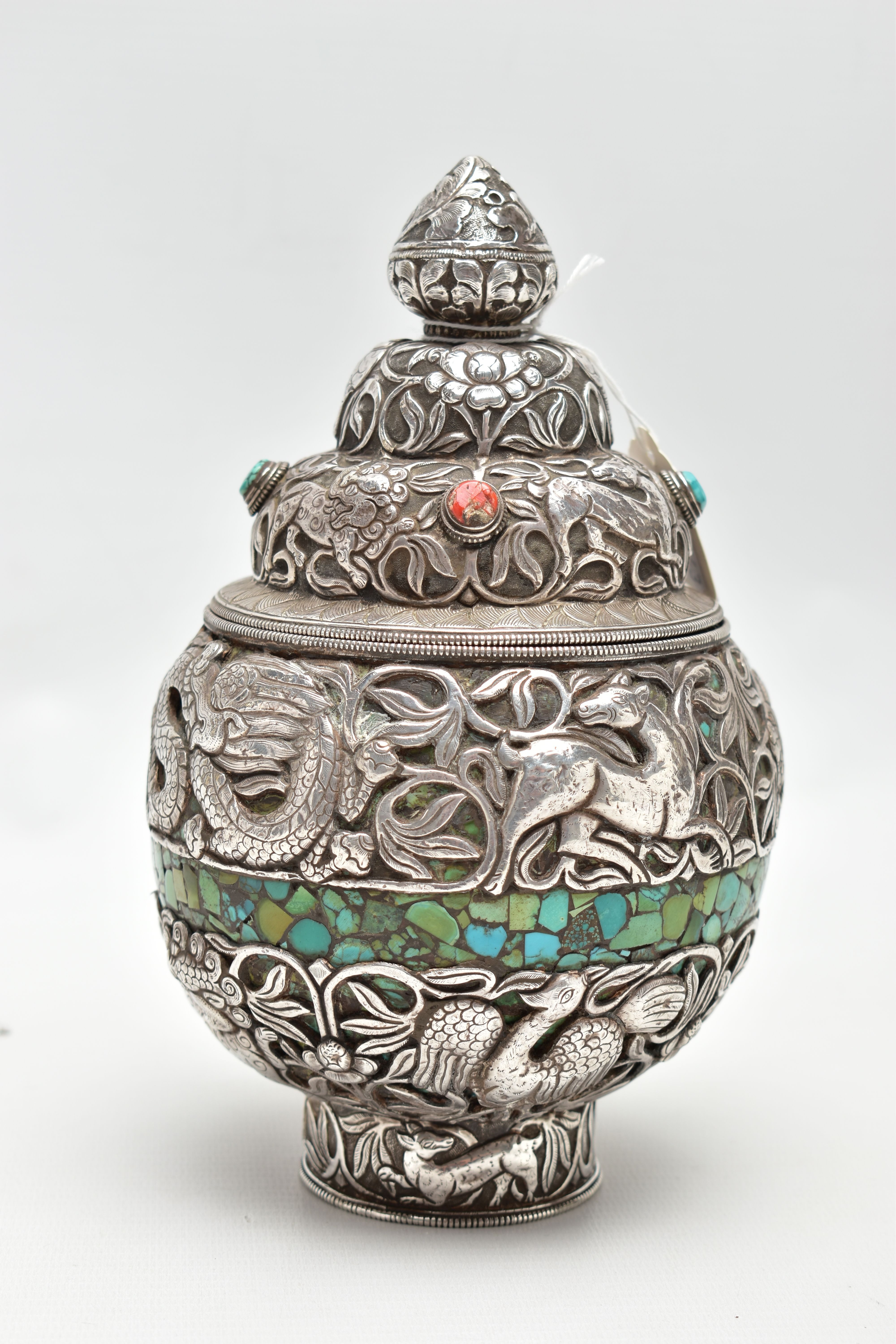 A WHITE METAL DECORATIVE VASE, detailed with tigers, lions, dragons and other animals within a