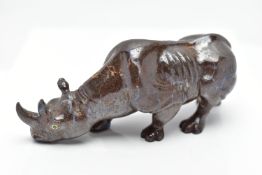 A CARVED BOULDER OPAL RHINO, the figure designed as a rhino, carved from boulder opal, with green