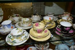A GROUP OF TWELVE ASSSORTED AYNSLEY HAND PAINTED TRIOS, varying in ages, shapes and patterns