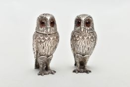 A PAIR OF SILVER NOVELTY OWL PEPPERETTES, each realistically textured with feathers, and both set