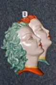 A GOLDSCHEIDER POTTERY DOUBLE WALL MASK, in the form of two ladies with orange or green hair,