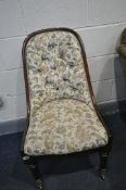 A VICTORIAN ROSEWOOD NURSING CHAIR, with floral upholstery (condition - slight splits to joins)