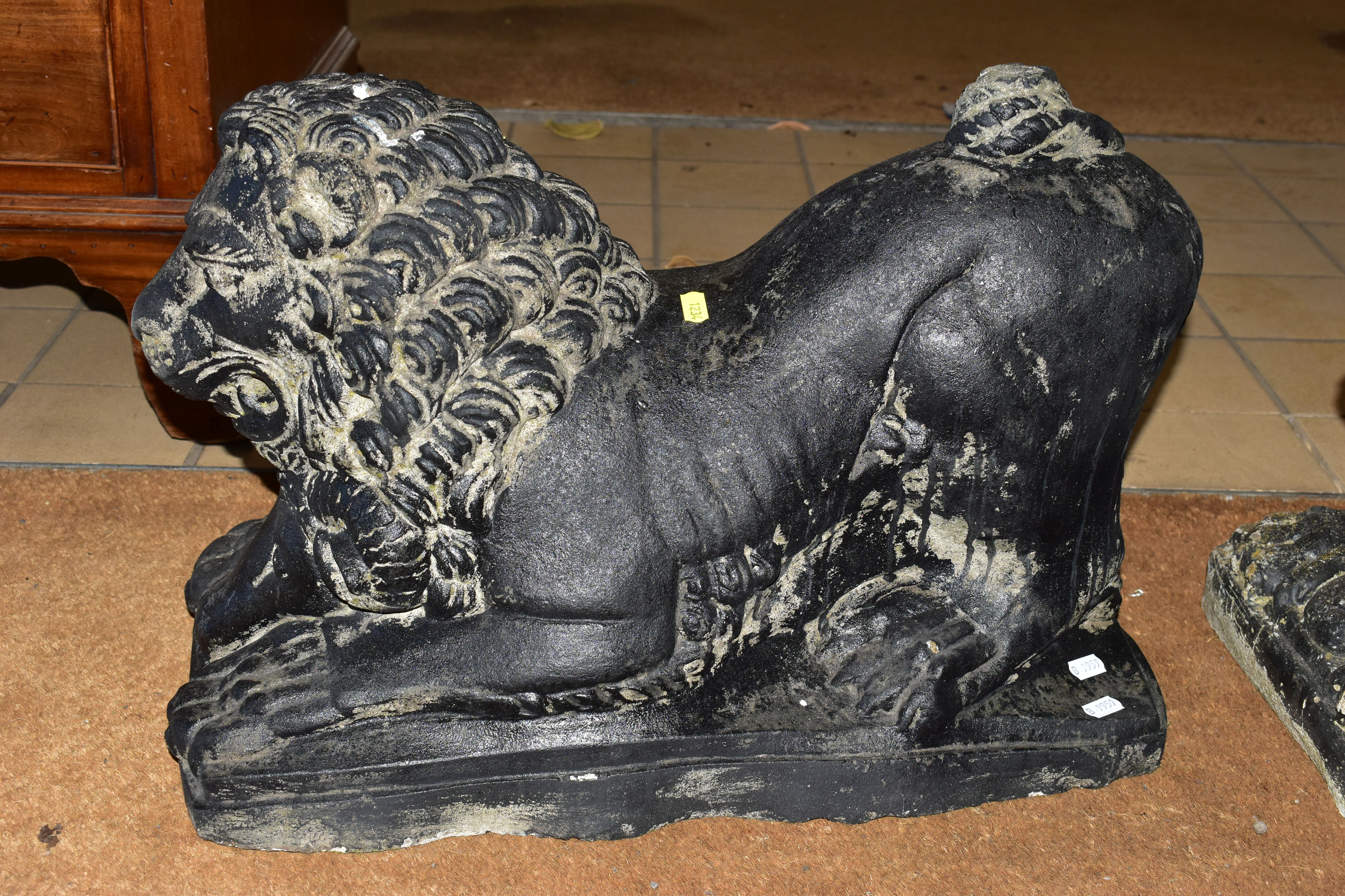 A PAIR OF BLACK PAINTED RECONSTITUTED CONCRETE GARDEN ORNAMENTS IN THE FORM OF LIONS, cast with a - Image 4 of 9