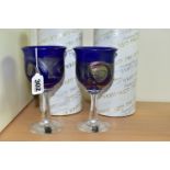 TWO BOXED ISLE OF WIGHT WINE GLASSES, each bowl in blue glass with a gold band and iridescent looped