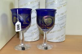 TWO BOXED ISLE OF WIGHT WINE GLASSES, each bowl in blue glass with a gold band and iridescent looped