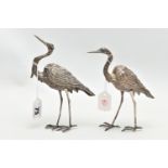 A PAIR OF WHITE METAL CRANE FIGURINES, realistically textured, approximate height 175mm, rubbed