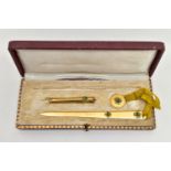 A CASED EARLY 20TH CENTUY GILT METAL AND ENAMELLED FOUR LEAF CLOVER DESIGN DESK/ WRITING SET, the