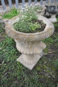 A COMPOSITE CAMPAGNA STYLE GARDEN URN with twin mask handles height 65cm