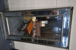 A LARGE RECTANGULAR BEVELED EDGE MIRROR, with foliate and studded decoration, 90cm x 183cm (
