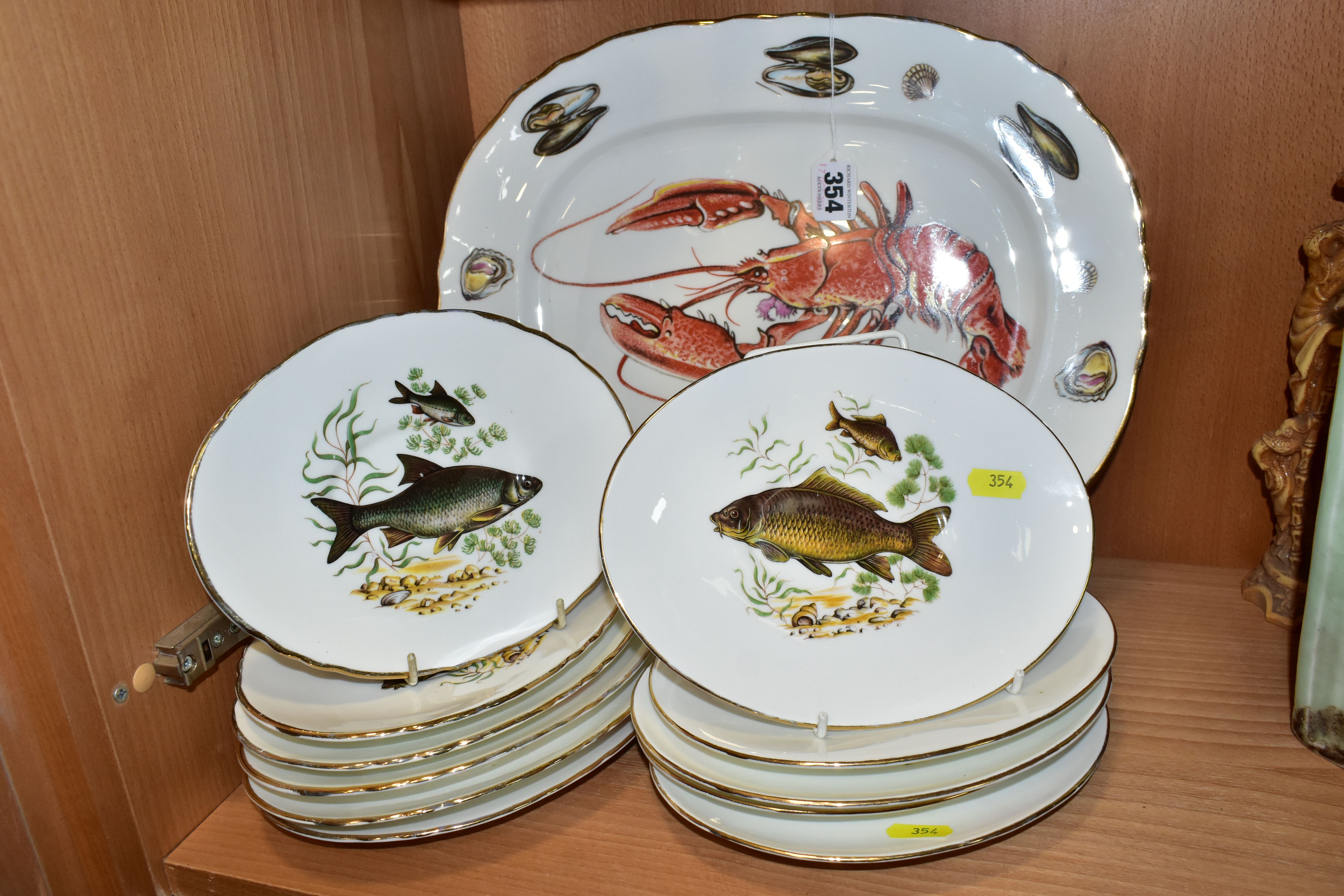 TWELVE PIECES OF AYNSLEY BONE CHINA PRINTED WITH FISH AND SHELLFISH DESIGNS, comprising an oval