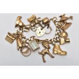 A 9CT GOLD CHARM BRACELET, a flat curb link bracelet, fitted with a heart padlock clasp,