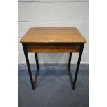 AN OAK SCHOOL DESK, with a hinged lid, a slot for an ink well, on cast iron legs, width 62cm x depth