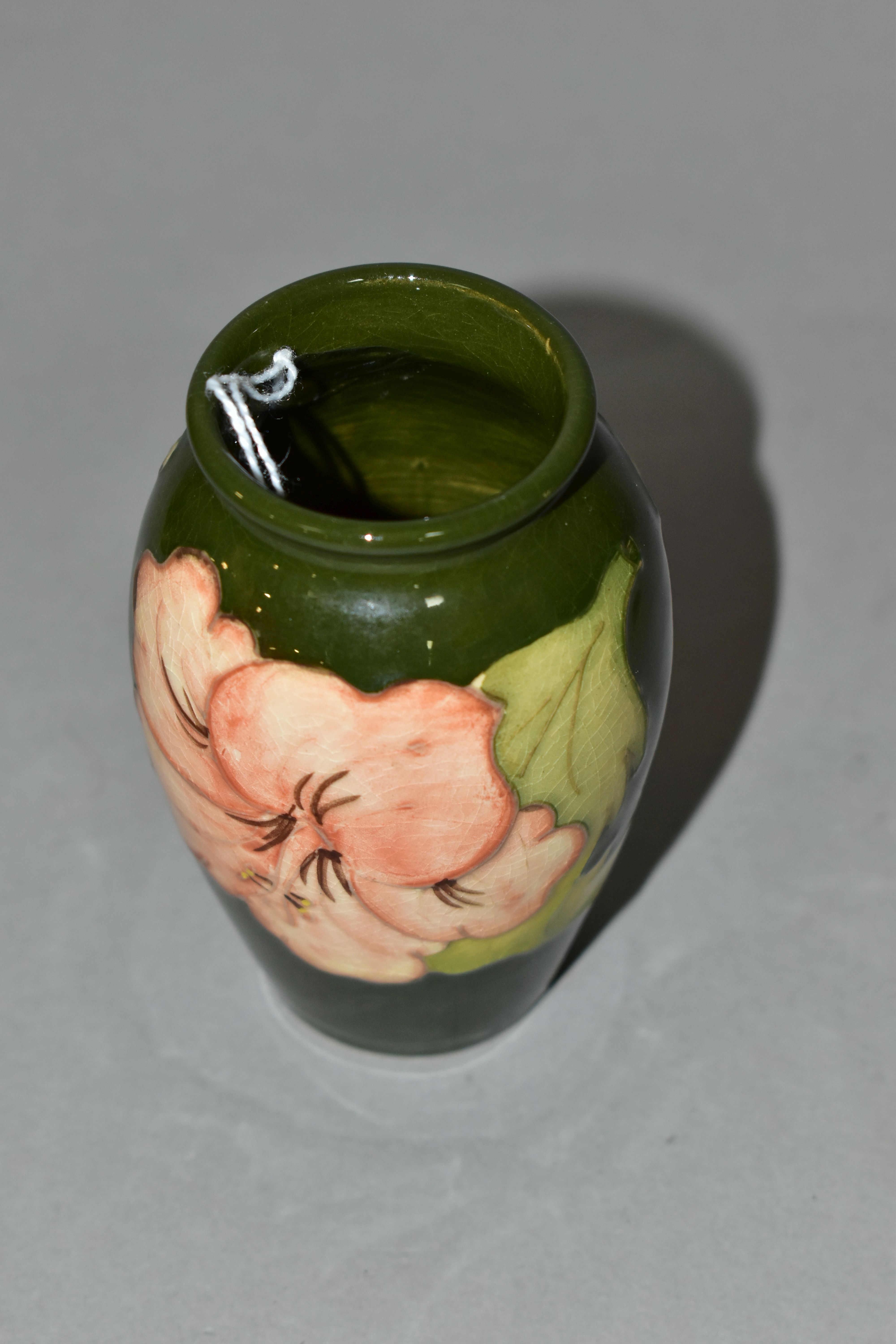 A MOORCROFT POTTERY BALUSTER SHAPED BUD VASE DECORATED WITH CORAL HIBISCUS ON A GREEN GROUND, - Image 3 of 4