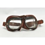 A PAIR OF WWI FLYING GOGGLES, with brown leather surround, clear glass angled lenses and grey