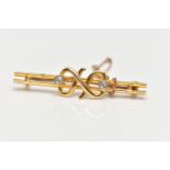 A YELLOW METAL DIAMOND SET BAR BROOCH, double polished bar with a central twist design flanked