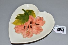 A MOORCROFT POTTERY HEART SHAPED PIN DISH DECORATED WITH A CORAL HIBISCUS ON A CREAM GROUND,