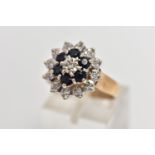 A 9CT GOLD SAPPHIRE AND DIAMOND CLUSTER RING, raised circular cluster, centering on a single cut