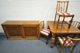 A 20TH CENTURY OAK EXTENDING DINING TABLE, on acorn legs, united by shaped stretchers, open length