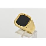 AN ONYX SIGNET RING, the square shape onyx panel, within a part textured and polished surround, to
