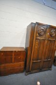 A 20TH CENTURY OAK TWO DOOR WARDROBE, the doors with a floral plaque, on bun feet, width 122cm x