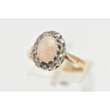 A 9CT GOLD OPAL AND DIAMOND CLUSTER RING, centering on an oval opal cabochon in a claw setting,