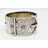 A WHITE METAL HINGED BANGLE, wide bangle approximate width 30.3mm, in the form of a belt and