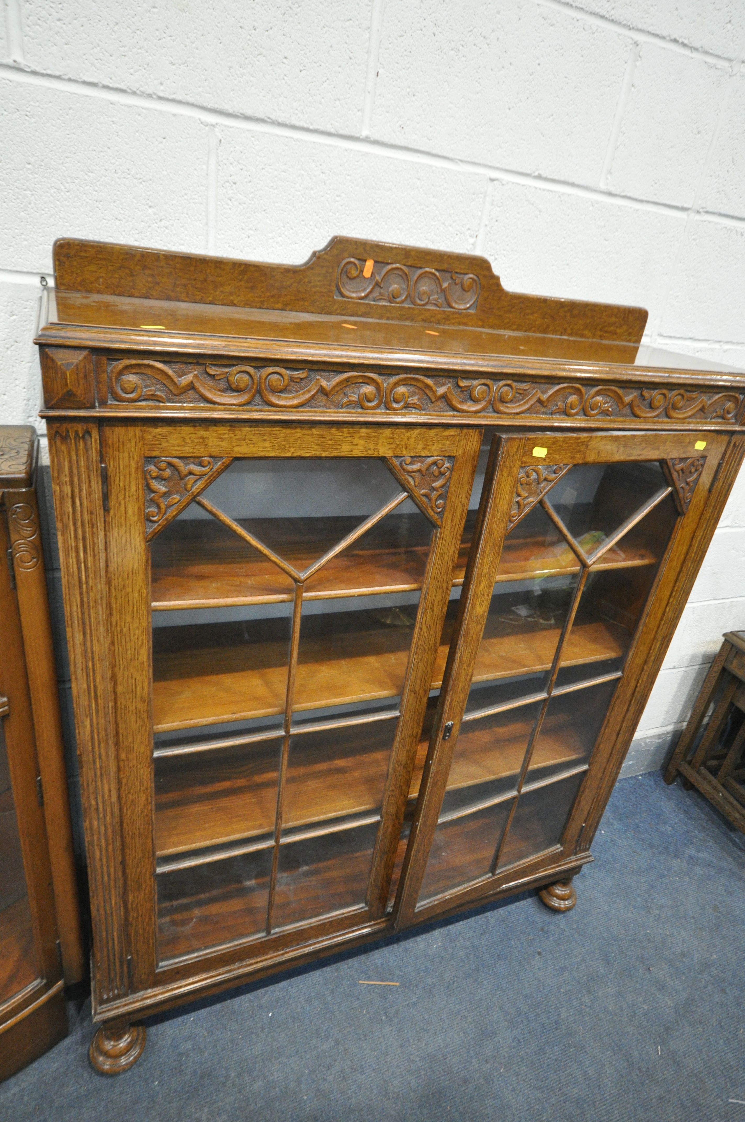 A 20TH CENTURY OAK SIDE BY SIDE BUREAU BOOKCASE, two glazed doors flanking a fall front door, - Image 4 of 4