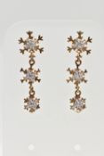 A PAIR OF 9CT YELLOW GOLD DROP EARRINGS, each designed with three graduating snowflakes, the top