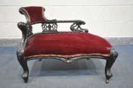 A 19TH CENTURY EBONISED CARVED WOOD SERPENTINE CHAISE LONGUE, of small proportions, having a