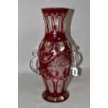 A LATE 19TH CENTURY BOHEMIAN GLASS TWIN HANDLED BALUSTER VASE, ruby stained and cut to clear with