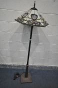 A METAL STANDARD LAMP, with a hexagonal Tiffany style shade, of foliate decoration, height 167cm (