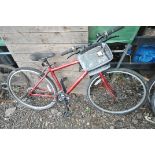 A RED APOLLO CX URBAN MOTION GENTLEMANS BICYCLE, with a 18 frame and Shimano Grip shift max gears