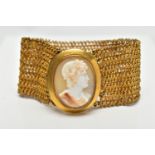 A YELLOW METAL AND SHELL CAMEO BRACELET, a wide yellow metal mesh bracelet, approximate width