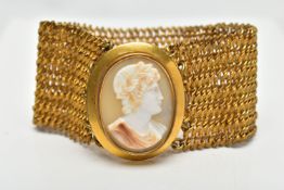 A YELLOW METAL AND SHELL CAMEO BRACELET, a wide yellow metal mesh bracelet, approximate width