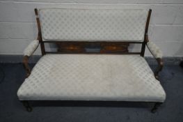 AN EDWARDIAN WALNUT AND INLAID SOFA, with swept open armrests, with floral upholstery, on turned